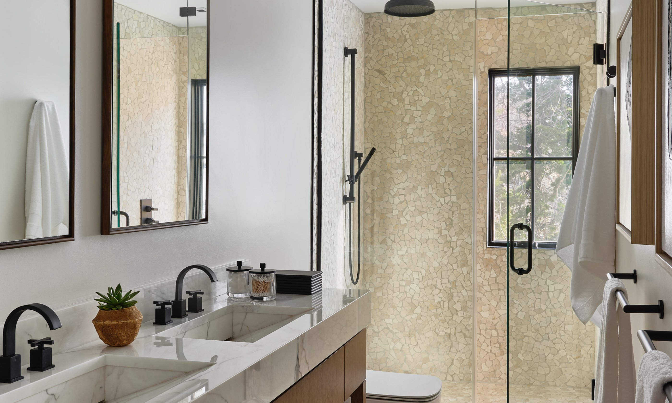 Bathroom with two sinks, two vanities, and walk-in shower.
