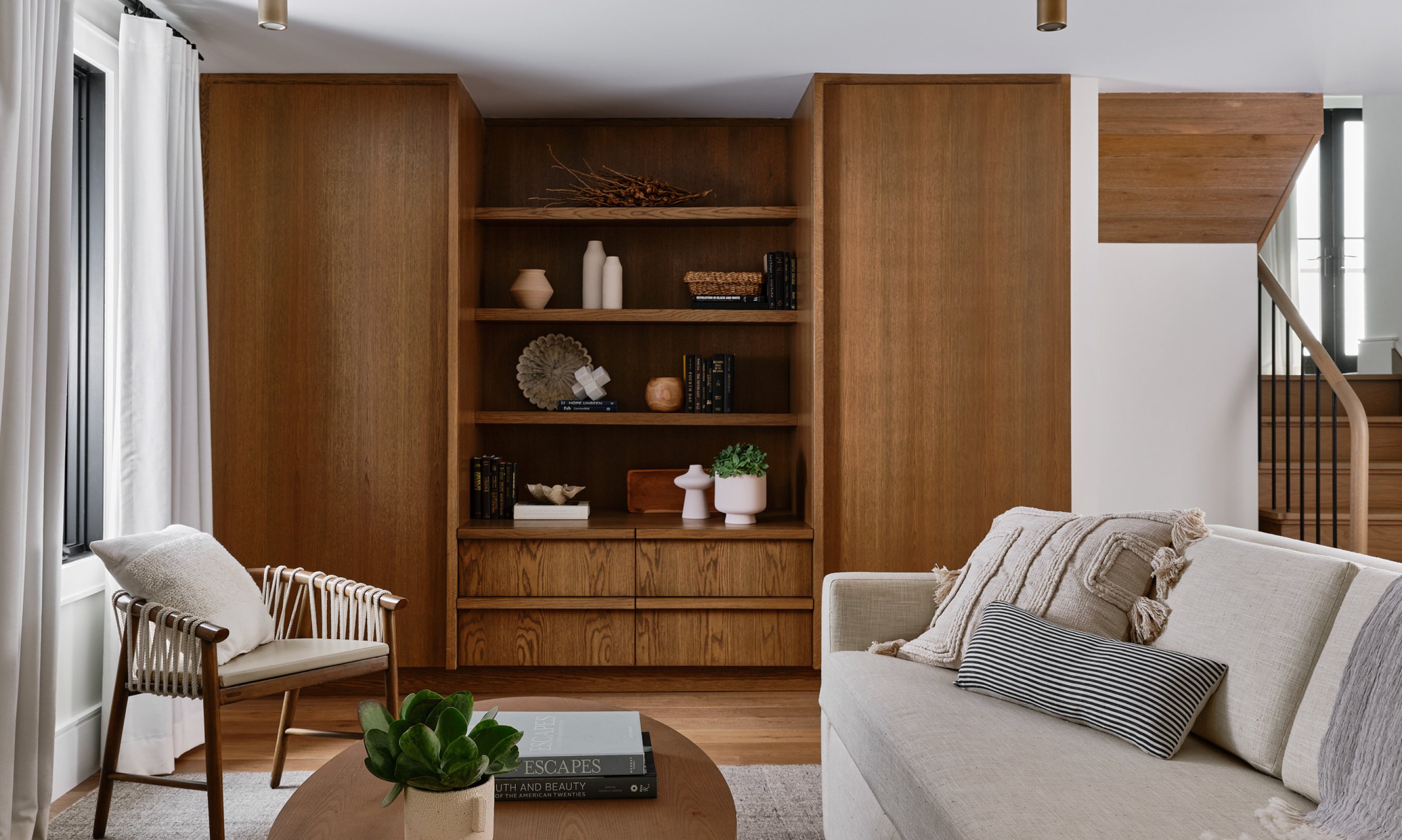 Downstairs sitting area with couch, chairs and coffee table.