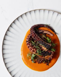 Octopus over a orange puree dish