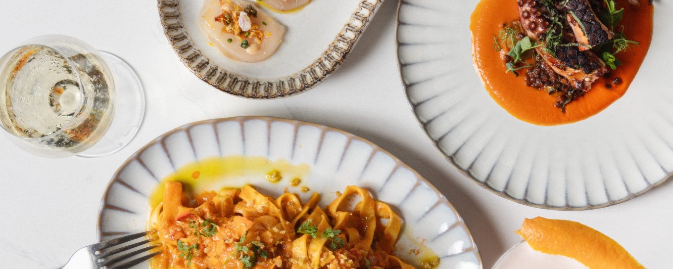 Pasta, sashimi, and octopus plated