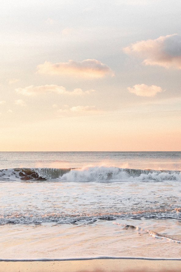Sunset with waves crashing on the beach