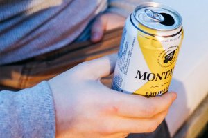 Man seated holding a can of beer at Gurney's Montauk Resort