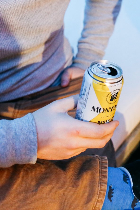 Man seated holding a can of beer at Gurney's Montauk Resort