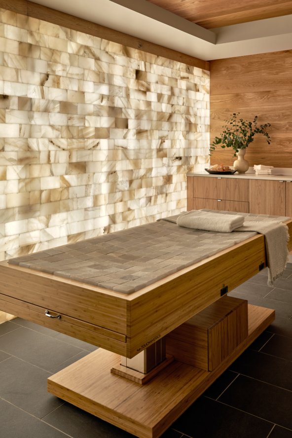 Treatment room with wood finishes and accent wall.