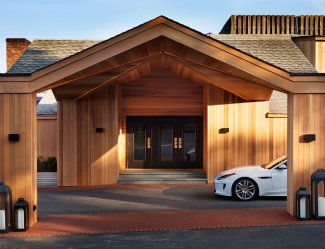 Drive in area with car an wooden design entrance