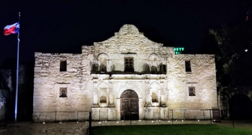 The Alamo at night with Texas flag, August 2019
